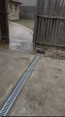 Stamped Patio & Drainage System - Installed a French drain system around a newly finished stamped concrete patio to prevent water buildup. The drain connects to a channel drain and continues with a foundation French drain along the house to redirect water away from the home, improving yard drainage and protecting the foundation! Stamped Patio & Drainage System - Installed a French drain system around a newly finished stamped concrete patio to prevent water buildup. The drain connects to a channel drain and continues with a foundation French drain along the house to redirect water away from the home, improving yard drainage and protecting the foundation!
