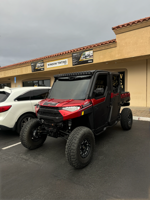 Trail-Ready Tint - This Polaris Ranger got an incredible upgrade with XR-Black Ceramic XPEL tint, Unlike ordinary tints, XR-Black Ceramic is engineered with advanced nano-ceramic particles that deliver unparalleled performance. With 88% heat rejection, it ensures the cabin stays cool even in intense sun, and its 99% UV protection safeguards passengers and the interior from harmful rays.

What sets XR-Black Ceramic apart from the competition is its superior durability, clarity, and glare reduction without interfering with visibility or signal transmission. It’s designed to resist fading and maintain its sleek appearance over time, making it the ultimate combination of style and functionality. Whether you're hitting the trails or cruising in the sun, this tint ensures maximum comfort, protection, and privacy. When it comes to quality, XPEL leads the pack!