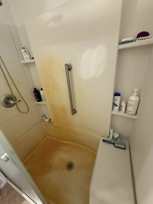 Shower Deep Clean - Before and after of a shower with hard water rust stains. Shower Deep Clean - Before and after of a shower with hard water rust stains.