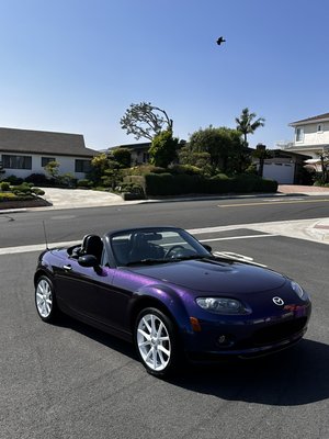 2010 Mazda Miata wrapped in Gloss Diamond Nebula Blue Purple - Mazda Miata in a sleek purple color-shifting wrap. 
The shade changes at different angles, giving the car a unique look. 
A great option for those who want something different.
