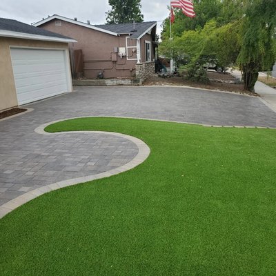 Paver Driveway & Artificial Grass - The client needed to add driveway space while significantly upgrading the curb appeal of this home. We removed the ugly mulch and old driveway before starting this beautiful ultra low maintenance front yard for this busy family. Paver Driveway & Artificial Grass - The client needed to add driveway space while significantly upgrading the curb appeal of this home. We removed the ugly mulch and old driveway before starting this beautiful ultra low maintenance front yard for this busy family.