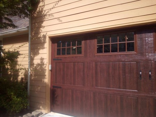 Custom Order Wood-Grain Steel Door - This 3 section, custom order garage door allows for many features that a traditional 4 section door does not. Large windows, wood grain finish, and decorate trim and hardware are just the beginning.