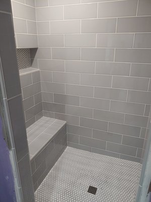 Bathroom Tiling Project - When we came in and did the bid there were no cabinets, sheetrock, NOTHING! Just wires hanging all over the place. I'm not sure what happened on the before pictures, but we ended up hanging the sheetrock, reframing a couple places, and building a false wall so we could install that 1 by 4 shower nicely. Call today for your tiling estimate!