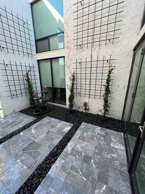 Zen Garden Oasis atrium in Arcadia - A Phoenix area zen walkway landscaping with wall wash lighting, pathway lights, black powder coated trellis with Star Jasmin vines, Travertine - brushed polar mist paver Roman Blu, and finally Black Polished river rock. Zen Garden Oasis atrium in Arcadia - A Phoenix area zen walkway landscaping with wall wash lighting, pathway lights, black powder coated trellis with Star Jasmin vines, Travertine - brushed polar mist paver Roman Blu, and finally Black Polished river rock.