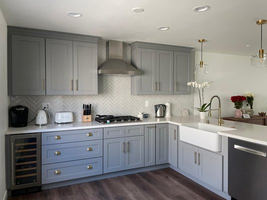 Kitchen Remodel Makeover! - This small kitchen was completely transformed into a modern, yet cozy look. They opened up the kitchen to have more useful space and cabinets! They put in a wine cooler, a spice rack and a Lazy Susan, making sure all the cabinets were symmetrical.