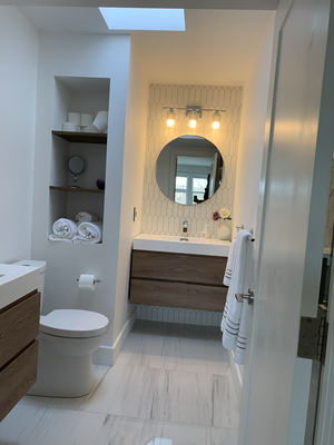 Modern Style Bathroom With Wall Mounted Vanity - Bathroom in a modern style with wood color details and a mosaic backsplash on the vanity Modern Style Bathroom With Wall Mounted Vanity - Bathroom in a modern style with wood color details and a mosaic backsplash on the vanity