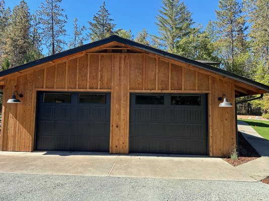 Residential Doors - When you need service for your home’s garage door, American Industrial Door has been the friendly and experienced technicians that residents in Southern Oregon and Northern California have called for over 43 years. This means that we have a quarter of a century’s worth of skills and knowledge to help you with anything you may need in regards to a new or your present garage door. American Industrial Door of Medford is the area expert for installation, repair and maintenance for all different types of garage doors, including both steel and wood doors.
Having the right garage door that is properly installed can add value to your home and increase security for your home, which is probably your biggest investment. When you are in the market for a new garage door, the first decision you will have to make is whether you want a wood or a steel garage door. While there are some benefits to each, garage doors made of wood generally need more upkeep than steel doors. Wooden garage doors will need to initially be painted to match your home and will need frequent repainting, just as the trim on your home tends to need. Steel doors are lower maintenance, have a longer warranty and are far more energy efficient since they are better insulated. The friendly technicians at American Industrial Door of Medford will be happy to help you make the best decision for your home. Residential Doors - When you need service for your home’s garage door, American Industrial Door has been the friendly and experienced technicians that residents in Southern Oregon and Northern California have called for over 43 years. This means that we have a quarter of a century’s worth of skills and knowledge to help you with anything you may need in regards to a new or your present garage door. American Industrial Door of Medford is the area expert for installation, repair and maintenance for all different types of garage doors, including both steel and wood doors.
Having the right garage door that is properly installed can add value to your home and increase security for your home, which is probably your biggest investment. When you are in the market for a new garage door, the first decision you will have to make is whether you want a wood or a steel garage door. While there are some benefits to each, garage doors made of wood generally need more upkeep than steel doors. Wooden garage doors will need to initially be painted to match your home and will need frequent repainting, just as the trim on your home tends to need. Steel doors are lower maintenance, have a longer warranty and are far more energy efficient since they are better insulated. The friendly technicians at American Industrial Door of Medford will be happy to help you make the best decision for your home.