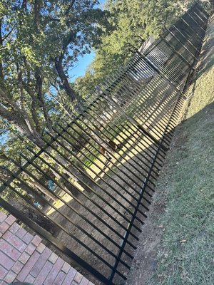 6ft Iron Fence Installation - Damaged wooden fence was replaced with Iron Fence Panels.  Each panel is 6 ft high 8 wide