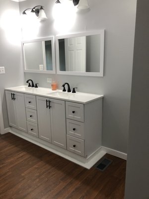 Bathroom remodeling - This bathroom was updated, fresh neutral gray paint, new double sink, mirrors, light fixture and new baseboards.