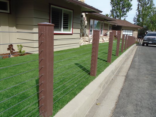 Modern Vinyl Fence + Cable Railing - Residential - We added a modern aesthetic to this home by adding a horizontal vinyl fence & stainless steel cable railing.