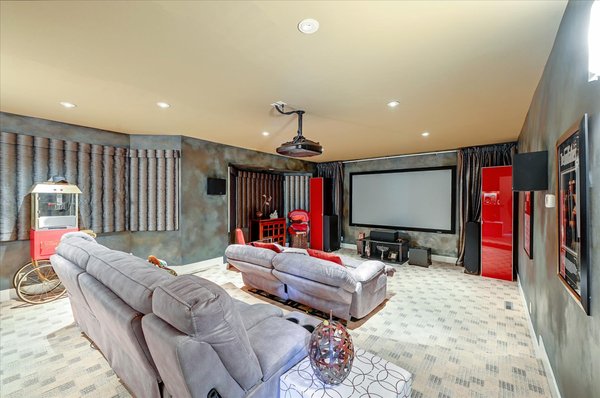 Custom In-Home Movie Theater - Custom family theater room. Each detail was perfectly installed from the stadium flooring, blackout curtains, projector placement, and quaint back bar. Custom In-Home Movie Theater - Custom family theater room. Each detail was perfectly installed from the stadium flooring, blackout curtains, projector placement, and quaint back bar.
