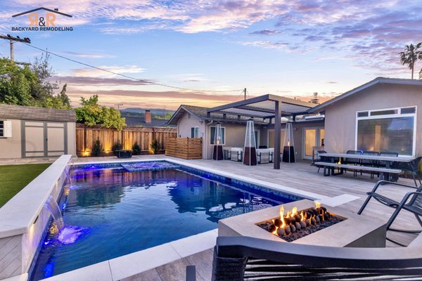 The Gregg Project | Front & Backyard Remodel - Introducing the Gregg Project in Los Gatos, CA. We recently completed a beautifully designed custom backyard featuring a luxurious pool and spa, complete with an automatic cover and elegant water features for both fun and relaxation. A roof-mounted Equinox louvered pergola provides adjustable shade and a seamless indoor-outdoor feel. Wood-look porcelain pavers bring warmth and durability, while lush landscaping adds a soft, inviting touch. This space was designed with both style and family living in mind - perfect for everyday enjoyment and effortless entertaining.