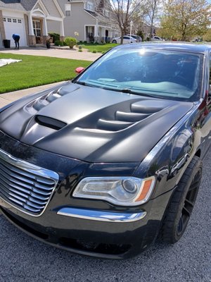 Satin Black vinyl wrap on a custom Chrysler 300 hood. - The owner of this 300 has done some incredible upgrades to his car, including swapping a Hellcat engine into it. He brought it to me with the custom hood looking flat white. After nearly a full day of detailed wrap work, here is the beautiful finished product! Satin Black vinyl wrap on a custom Chrysler 300 hood. - The owner of this 300 has done some incredible upgrades to his car, including swapping a Hellcat engine into it. He brought it to me with the custom hood looking flat white. After nearly a full day of detailed wrap work, here is the beautiful finished product!