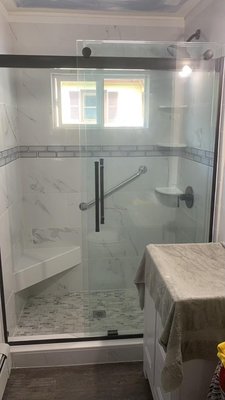 Bathroom Remodel - This shower was completely redone with new tiles, seating, fixtures and door. Bathroom Remodel - This shower was completely redone with new tiles, seating, fixtures and door.