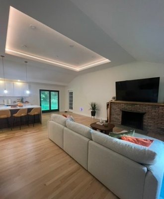 Open concept living in a modern ranch home - Transformed this dated living room into a bright, modern open concept living space. Updates included new flooring, recessed lighting, ceiling detail, fresh paint, and a clean fireplace refresh to create a more inviting layout. Open concept living in a modern ranch home - Transformed this dated living room into a bright, modern open concept living space. Updates included new flooring, recessed lighting, ceiling detail, fresh paint, and a clean fireplace refresh to create a more inviting layout.
