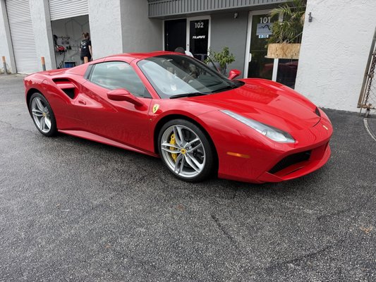 2018 Ferrari 488 GTB — Full Paint Protection Film & Ceramic Coating | Ceramic Window Tint | Filmwave West Palm Beach - This Rosso Corsa 2018 Ferrari 488 GTB came to Filmwave West Palm Beach for the full protection treatment it deserves.
Before any film touched the paint, our team performed a thorough mechanical decontamination to remove all bonded surface contaminants — giving us a perfectly clean foundation to work from.
We then completed a full-vehicle Paint Protection Film installation. To ensure a flawless, seamless result, we removed the mirrors, door handles, emblems, and lights so every panel edge could be properly tucked and wrapped underneath. No cutting around components, no exposed edges — just clean, invisible protection across every panel.
Once the PPF was set, we applied a premium ceramic coating over the entire exterior, locking in a hydrophobic, UV-resistant finish that enhances the depth of that iconic Rosso Corsa paint. The interior received a full ceramic treatment as well, protecting every surface inside the cabin.
The result is a Ferrari that looks factory fresh, is shielded from rock chips, road debris, UV damage, and environmental contaminants — and will stay that way for years to come.
Filmwave specializes in paint protection film, ceramic coating, and window tint for exotic and luxury vehicles across West Palm Beach and South Florida.