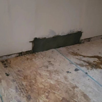 kitchen and livingroom with repaired walls and paint with new floors ready for them to install trim - house in bad condition with new floors and walls texture and paint