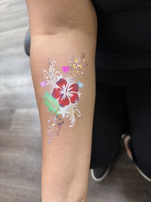 Airbrush Art - Our Airbrush Tattoos bring fast, customized fun to any event. Using skin-safe, water-resistant paints, we create vibrant designs that last through parties, playtime, and even water activities. From simple shapes to detailed patterns, guests can choose from a wide variety of styles — all applied quickly and professionally to keep the line moving and the excitement high. In addition to tattoos, our Airbrush Art also includes custom work on canvas, t-shirts, hats, and more — perfect for personalized keepsakes and event mementos. Explore the gallery to see both body art and wearable creations in action!