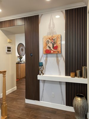 Dublin Foyer 2024 - This foyer started as a plain wall and was transformed into a welcoming feature that blends elegance with tradition. The new design includes crown molding, a faux marble backdrop framed with warm wood slats, and a custom floating shelf for both style and function. It’s the perfect spot to showcase décor while keeping daily essentials within reach as the family enters or leaves the home. Dublin Foyer 2024 - This foyer started as a plain wall and was transformed into a welcoming feature that blends elegance with tradition. The new design includes crown molding, a faux marble backdrop framed with warm wood slats, and a custom floating shelf for both style and function. It’s the perfect spot to showcase décor while keeping daily essentials within reach as the family enters or leaves the home.