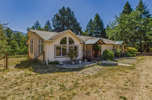 281 Peach Orchard Road Salyer, CA 95563 Salyer, CA 95563 - Discover the perfect blend of space, comfort, and natural beauty on 5.5 acres of flat, lush land surrounded by stunning views of the Trinity Alps. This impressive home offers 3 bedrooms plus a bonus room, 2 bathrooms, including an en-suite primary bath, and soaring vaulted ceilings throughout. The gourmet-style kitchen features abundant cabinetry and opens to an expansive living room filled with windows and natural light. A large dining area and separate family room provide plenty of space for entertaining and everyday living. Outside, enjoy established fruit trees, two outbuildings, and an incredible 4-car garage with power--ideal for vehicles, hobbies, storage, or a workshop. Located just minutes from the Trinity River.