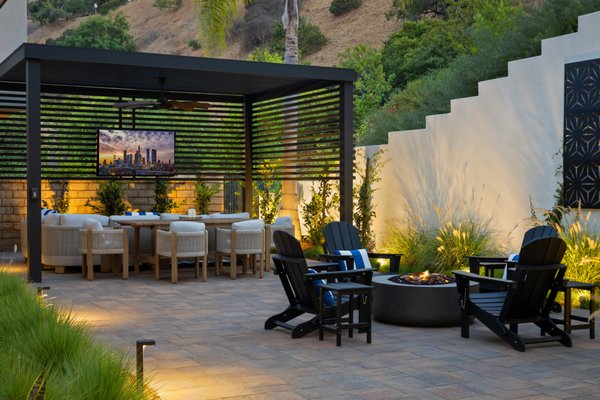Hollywood Hills - This Hollywood Hills backyard landscape project successfully transformed a neglected and underutilized outdoor space into a beautiful, functional, and sustainable retreat. Every element was designed with careful attention to detail, from the drainage and irrigation systems to the custom features such as the decorative wall art, fire pit, and aluminum fencing. The combination of Belgard pavers, drought-tolerant planting, and native grasses created a harmonious balance between hardscape and softscape, offering a perfect blend of aesthetics and practicality. The result is a space that invites relaxation, encourages outdoor living, and enhances the beauty of the Hollywood Hills while being environmentally responsible and low-maintenance. Hollywood Hills - This Hollywood Hills backyard landscape project successfully transformed a neglected and underutilized outdoor space into a beautiful, functional, and sustainable retreat. Every element was designed with careful attention to detail, from the drainage and irrigation systems to the custom features such as the decorative wall art, fire pit, and aluminum fencing. The combination of Belgard pavers, drought-tolerant planting, and native grasses created a harmonious balance between hardscape and softscape, offering a perfect blend of aesthetics and practicality. The result is a space that invites relaxation, encourages outdoor living, and enhances the beauty of the Hollywood Hills while being environmentally responsible and low-maintenance.