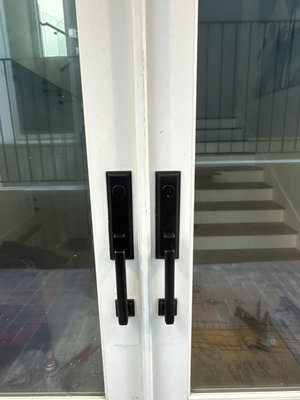 Exterior Double Door Lock Replacement - We were called to replace old, worn-out patio door handles that were sticking and no longer locking properly. The finish was faded and the interior mechanics were corroded from years of exposure. We removed the damaged hardware and installed new, oil-rubbed bronze handlesets that not only improved security but also elevated the overall appearance of the doors. Smooth operation and a clean, elegant finish completed the upgrade.