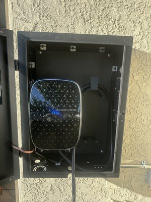 Mercedes-Benz EV Charger Installation - This project was a complete installation of a Mercedes-Benz Level 2 Home Charger, paired with a custom outdoor-rated steel enclosure to ensure long-term protection and clean aesthetics. The homeowner wanted a setup that looked polished, blended with the property, and delivered reliable daily charging without exposing the charger to weather or sun damage.
We began by identifying the best exterior mounting location with proper structural support and safe cable routing. Once we determined the placement, we installed a dedicated EV circuit sized specifically for the Mercedes-Benz charger’s power requirements, ensuring the system would handle full charging loads without affecting the rest of the home’s electrical system. All conductors were run in protected, code-compliant conduit and secured tightly for both safety and longevity.
After bringing power to the location, we mounted the weatherproof enclosure and anchored it cleanly to the wall. Inside the enclosure, we installed the Mercedes-Benz charger with precise alignment and proper spacing for ventilation. Every cable was routed cleanly, secured to the enclosure, and tested to confirm strong electrical connections. The charger’s internal wiring was organized for maximum protection and ease of access, avoiding any exposed or loose conductors.
With the charger mounted and wired, we performed a series of load tests to confirm that the dedicated circuit delivered stable power and that the charger communicated properly with the vehicle Mercedes-Benz EV Charger Installation - This project was a complete installation of a Mercedes-Benz Level 2 Home Charger, paired with a custom outdoor-rated steel enclosure to ensure long-term protection and clean aesthetics. The homeowner wanted a setup that looked polished, blended with the property, and delivered reliable daily charging without exposing the charger to weather or sun damage.
We began by identifying the best exterior mounting location with proper structural support and safe cable routing. Once we determined the placement, we installed a dedicated EV circuit sized specifically for the Mercedes-Benz charger’s power requirements, ensuring the system would handle full charging loads without affecting the rest of the home’s electrical system. All conductors were run in protected, code-compliant conduit and secured tightly for both safety and longevity.
After bringing power to the location, we mounted the weatherproof enclosure and anchored it cleanly to the wall. Inside the enclosure, we installed the Mercedes-Benz charger with precise alignment and proper spacing for ventilation. Every cable was routed cleanly, secured to the enclosure, and tested to confirm strong electrical connections. The charger’s internal wiring was organized for maximum protection and ease of access, avoiding any exposed or loose conductors.
With the charger mounted and wired, we performed a series of load tests to confirm that the dedicated circuit delivered stable power and that the charger communicated properly with the vehicle