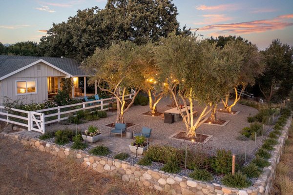 The Starter Farm - What was once a deteriorating raised garden bed and a steep, unusable hillside has now become a vibrant outdoor sanctuary. We transformed the space by installing custom water features — including a hand-cut millstone and a unique fountain — each equipped with automatic fills so the homeowners never have to worry about refilling water.

To ground the setting with timeless beauty, we brought in mature 75-year-old olive trees, creating an atmosphere that feels both established and inviting. The result is a stunning garden and outdoor dining experience that can be enjoyed day and night — a space where nature, comfort, and craftsmanship come together seamlessly.