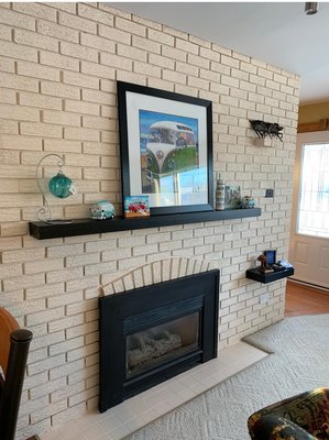 Fireplace remodel - This job was on an old brick fireplace. We completely transformed it with a gallon of paint. Now it pops more, looks clean, and blends into the house more.