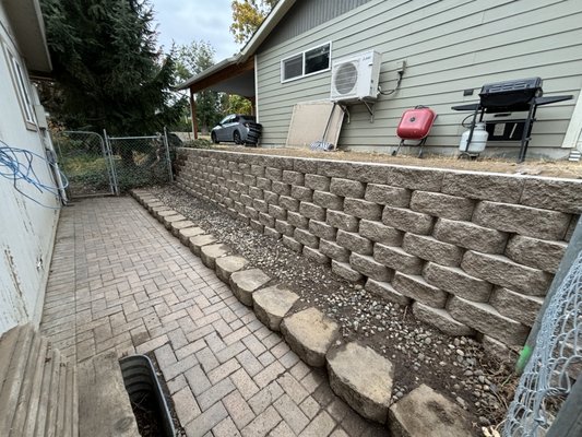 construction of retaining wall East Wenatchee - This wall was built to delimit the property together with the neighbor's. It has a length of 70 feet by 4 feet high approximately. The work was finished and we had to completely remove a 50-foot-tall tree to complete the project.