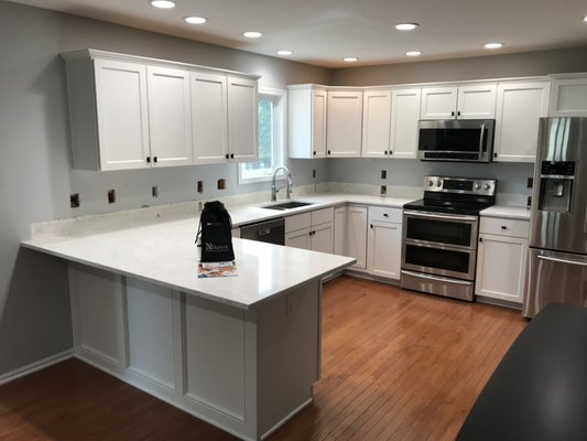 Cabinet Door Replacement August 2022 - This kitchen started off with the typical honey oak cabinets of the early 2000’s and ended up with a clean and fresh look.  New doors and drawer fronts with soft close hinges and updated hardware.  All in about a week!