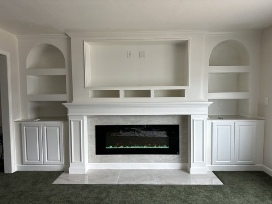 Custom Built-in Fireplace Media Wall in the PB - Custom built-in fireplace media wall featuring 24-inch-deep cabinets, arched niches, shelving, fireplace integration, tile work, and finish carpentry. All elements were built on site to create a functional and elegant focal point with integrated storage and display space. Custom Built-in Fireplace Media Wall in the PB - Custom built-in fireplace media wall featuring 24-inch-deep cabinets, arched niches, shelving, fireplace integration, tile work, and finish carpentry. All elements were built on site to create a functional and elegant focal point with integrated storage and display space.