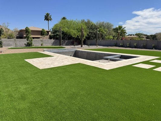 Pet-Friendly Turf, Travertine Pool Deck, Putting Green - We did this big backyard for a customer in Chandler. Featured pet-friendly artificial grass lawn, travertine paver pool deck, patio, walkways. Plus a putting green in the background! Pet-Friendly Turf, Travertine Pool Deck, Putting Green - We did this big backyard for a customer in Chandler. Featured pet-friendly artificial grass lawn, travertine paver pool deck, patio, walkways. Plus a putting green in the background!