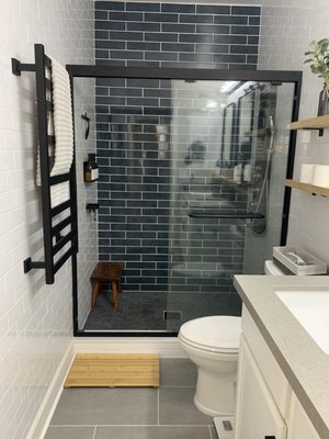 Bathroom Remodel - This was a remodel from an outdated bathroom. We tore up the tub and remodeled the entire bathroom. Subway tile all around with an accent wall on the back and tile on the floor as well. New shower tower, floating shelves, towel warmer, glass shower door, new mirrors and addition of a magnifying mirror as well. Bathroom Remodel - This was a remodel from an outdated bathroom. We tore up the tub and remodeled the entire bathroom. Subway tile all around with an accent wall on the back and tile on the floor as well. New shower tower, floating shelves, towel warmer, glass shower door, new mirrors and addition of a magnifying mirror as well.