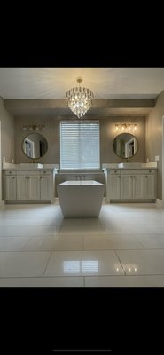 Master bathroom remodel  - This was a full demo remodel of a master bathroom with stand alone tub. Existing cabinetry refurbished with a white lacquer finish. Lighting provided by home owners and marble tile flooring for that luxurious feel. Master bathroom remodel  - This was a full demo remodel of a master bathroom with stand alone tub. Existing cabinetry refurbished with a white lacquer finish. Lighting provided by home owners and marble tile flooring for that luxurious feel.