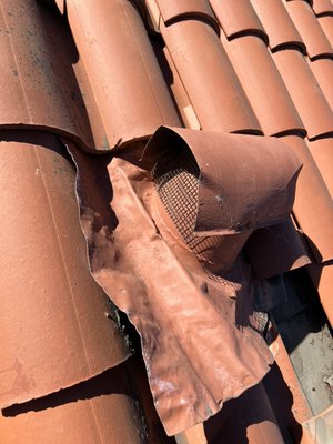 The right way to close an entry point! - This house had previously had someone do a rodent exclusion on the home. This vent was not properly sealed so the rodents had continued access to the attic space. We removed the roof tiles to expose the hole underneath the surface vent. The rodent can access under the tiles so it is important the hole is close under the tiles. We meshed it and then used cement to create a repair to an entry point that we offer a lifetime warranty on. Lastly the inner vent duct was also screened before reassembling the roof tiles and vent.
