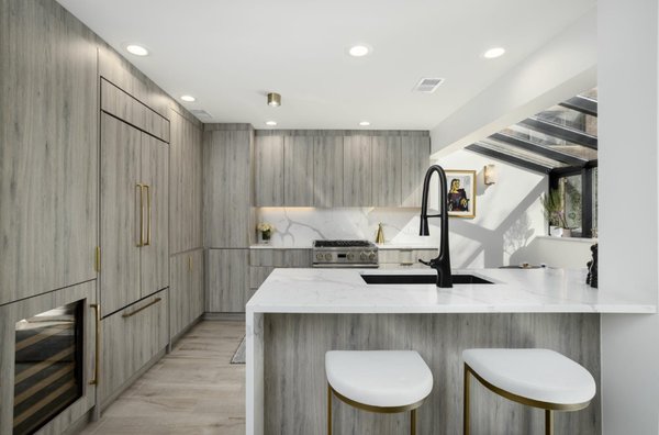 Vine Kitchen and Powder Room: Modern Minimalist Renovation - This project transforms the first-floor kitchen and powder room using white quartz countertop, pale grey wood laminate cabinetry and drawers. Black and brass accents and fixtures. The result is a clean, modern, and minimalist interior that feels bright, refined, and inviting. Vine Kitchen and Powder Room: Modern Minimalist Renovation - This project transforms the first-floor kitchen and powder room using white quartz countertop, pale grey wood laminate cabinetry and drawers. Black and brass accents and fixtures. The result is a clean, modern, and minimalist interior that feels bright, refined, and inviting.