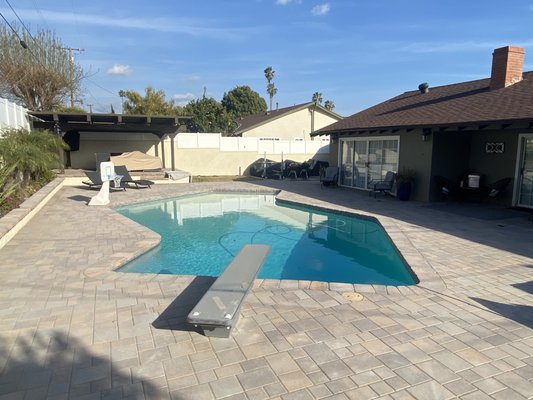 Backyard Makeover with Pavers around Pool - This backyard was completely transformed into a modern, functional outdoor living space. The renovation includes new pavers, a sleek pool area, improved lighting, and lush landscaping. The space is designed for both relaxation and entertainment, giving it a fresh, inviting feel. Backyard Makeover with Pavers around Pool - This backyard was completely transformed into a modern, functional outdoor living space. The renovation includes new pavers, a sleek pool area, improved lighting, and lush landscaping. The space is designed for both relaxation and entertainment, giving it a fresh, inviting feel.