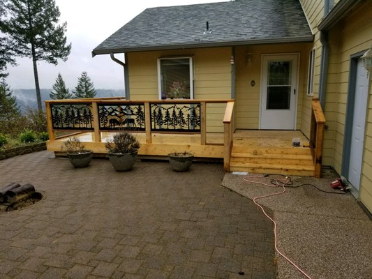Alaskan Yellow Cedar Deck in Lilliwaup - Embark on a journey of resilience and refinement with a very special project - a brand-new deck born from the ashes of adversity. Crafted from the illustrious Alaskan Yellow Cedar, this deck stands as a testament to strength and beauty, rising from the remnants of a lightning strike with grace and grandeur.

As you step onto the smooth, inviting surface of the Alaskan Yellow Cedar decking, you're greeted by the warmth of its natural hues and the unmistakable aroma of AYC. Each plank whispers tales of endurance, promising years of enjoyment under the open sky.

But it's not just the decking that captures the imagination - behold the striking contrast of metal and glass railing, a modern marvel that effortlessly blends functionality with sophistication. With unobstructed views and sturdy support, this railing invites you to revel in the surrounding landscape without compromise.

Together, these elements form a sanctuary of serenity and strength, a beacon of hope rising from the ashes of the past. Join us in celebrating resilience and renewal as we welcome you to this exquisite new deck, where every moment is a testament to the power of perseverance and the beauty of transformation."