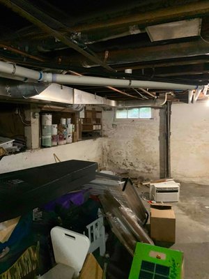Basement Waterproofing in Portland, OR - This homes basement had been leaking on and off for years. The owners had applied a waterproof paint along the foundation walls, but this bubbled and cracked, letting water re-enter the space. To provide a long term solution they contacted John's Waterproofing. We installed a full drain system, sump pump, BrightWall paneling, and a dehumidifier.