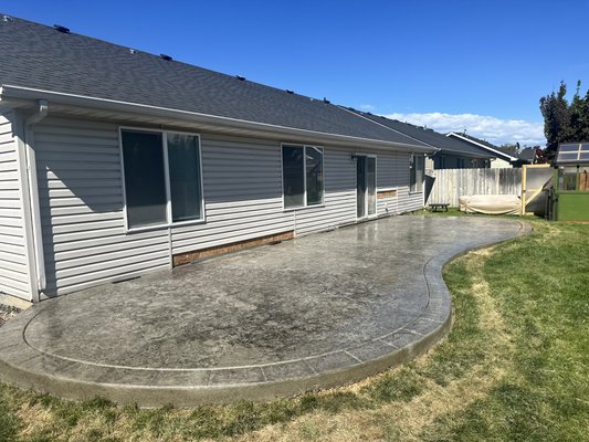 Stamped back patio - This project we did a stamped back patio, rocks down the side yard, and driveway extensions for this house and the neighbors Stamped back patio - This project we did a stamped back patio, rocks down the side yard, and driveway extensions for this house and the neighbors