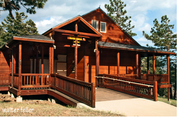 GRASSY HOLLOW VISITORS CENTER - The Grassy Hollow Visitor Center is about six miles west of Wrightwood on the scenic Angeles Crest Highway (State Route 2) near Inspiration Point. This spacious, open-beamed redwood building is surrounded by a deck from which visitors can experience panoramic views of the mountains and the valley below. A favorite of visitors is the southern portion of the deck which features a fully accessible bird viewing area that was designed with the help of the Audubon Society.
Grassy Hollow houses exhibits, including an extensive wildlife display, a gift shop and an information desk. The Center offers the visitor an engaging atmosphere in which to learn about the flora, fauna, and natural history of the San Gabriel Mountains.
Surrounding the Visitor Center building is the Grassy Hollow picnic area where picnic tables, barbecues, and restrooms provide a pleasant, relaxing atmosphere. The Pacific Crest Trail is adjacent to the picnic grounds and the Grassy Hollow Campground is nearby. GRASSY HOLLOW VISITORS CENTER - The Grassy Hollow Visitor Center is about six miles west of Wrightwood on the scenic Angeles Crest Highway (State Route 2) near Inspiration Point. This spacious, open-beamed redwood building is surrounded by a deck from which visitors can experience panoramic views of the mountains and the valley below. A favorite of visitors is the southern portion of the deck which features a fully accessible bird viewing area that was designed with the help of the Audubon Society.
Grassy Hollow houses exhibits, including an extensive wildlife display, a gift shop and an information desk. The Center offers the visitor an engaging atmosphere in which to learn about the flora, fauna, and natural history of the San Gabriel Mountains.
Surrounding the Visitor Center building is the Grassy Hollow picnic area where picnic tables, barbecues, and restrooms provide a pleasant, relaxing atmosphere. The Pacific Crest Trail is adjacent to the picnic grounds and the Grassy Hollow Campground is nearby.