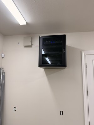 Secondary AV Rack - This was a system takeover and the customer wanted a secondary AV rack to cover this OnQ panel and to cable manage the wires. So we provided an on wall AV Rack solution that is connected to the main house by a fiber cable capable of providing 10GBE speeds! The rack is about 90% complete, just waiting on a UPS backup power to be delivered and installed! Secondary AV Rack - This was a system takeover and the customer wanted a secondary AV rack to cover this OnQ panel and to cable manage the wires. So we provided an on wall AV Rack solution that is connected to the main house by a fiber cable capable of providing 10GBE speeds! The rack is about 90% complete, just waiting on a UPS backup power to be delivered and installed!