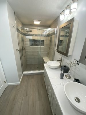 Bathroom Remodel - This was a complete gut job top to bottom. Our team worked with our client to design this bathroom completely custom to their vision. From the vessel sinks, electrical, shower design, and tile design. We love to go above and beyond to give our clients exactly what they envision for their project. Bathroom Remodel - This was a complete gut job top to bottom. Our team worked with our client to design this bathroom completely custom to their vision. From the vessel sinks, electrical, shower design, and tile design. We love to go above and beyond to give our clients exactly what they envision for their project.
