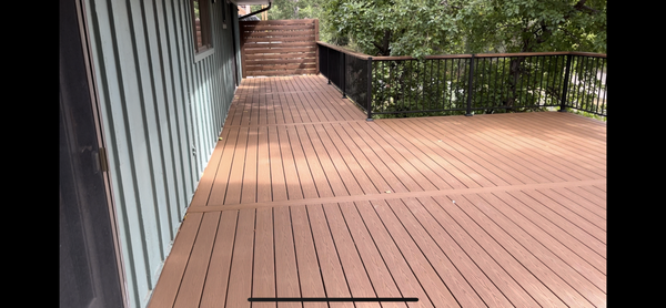 Deck Replacement - This customer had an old deck that was falling apart. She really wanted something that could work for her situation. Her existing deck didn't have stairs to below. So we added stairs with a landing in order to give her access to her patio below. It took some exact calculating to make it happen, but we were able to make it happen. And now she has an incredible outdoor space for her and her family. This deck was so large it was hard to get it all in one photo.