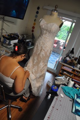 Wedding Dress - A wedding dress that was recently brought to me by a client. I hemmed the dress, altered the fit from the back, shortened the straps, repaired the corset loop and resized the modesty panel for the lace up in the back of the corset. I also replaced lace and beading. Wedding Dress - A wedding dress that was recently brought to me by a client. I hemmed the dress, altered the fit from the back, shortened the straps, repaired the corset loop and resized the modesty panel for the lace up in the back of the corset. I also replaced lace and beading.