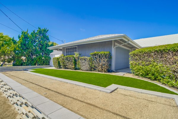 Front Yard Landscape Design and Installation Featuring Retaining Wall - This front yard landscape project includes upgraded driveway pavers, water-efficient artificial turf, and a custom-designed retaining wall. Completed in San Diego, CA. Front Yard Landscape Design and Installation Featuring Retaining Wall - This front yard landscape project includes upgraded driveway pavers, water-efficient artificial turf, and a custom-designed retaining wall. Completed in San Diego, CA.