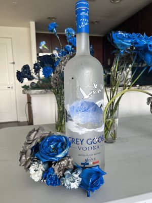 Georgetown graduation - The client needed custom blue and grey flowers and wanted to add flowers to Grey Goose bottles.