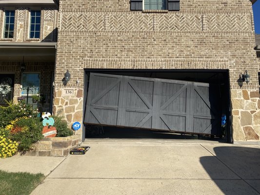 Garage Door Repair in Denton Texas - Cable Off - This was a garage door repair in Denton Texas.  The garage door cables had been thrown due to an obstacle in the path of the door causing one side of the door to stop when it was lowering.  The repair took about an hour and a half and required a lot of planning due to the size and weight of the door.  This is a very dangerous garage door repair and should never be undertaken by someone who is not a professional.  We are trained and experienced with these types of repairs and know how to repair the garage door with minimal risks to person or property.  Yes, these repairs can be expensive, but hospital bills are more expensive.  Call the garage door professionals at AGS - Home Services next time you have a cable off.