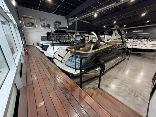 Newly finished indoor Pontoon Boat display - We just finished our new pontoon boat display and are excited for our customer to see it.  Now you can easily view all the beautiful Harris Pontoon boats LMC Marine Center Carries while inside our air conditioned facility.  From value 21 footers to super luxury 27 footers, we have them all!